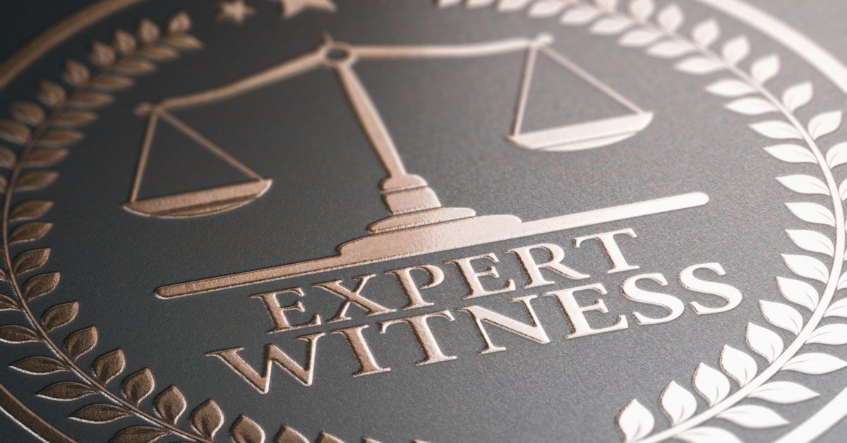 A close-up shot of a black and bronze logo with the scales of justice and the words