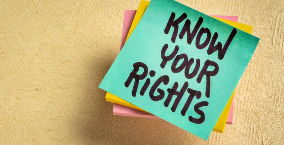 A stack of turquoise, yellow, and pink post-it notes, with the top note displaying 