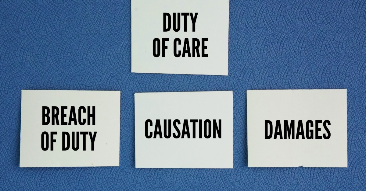 White paper cards labeled duty of care, breach of duty, causation, and damages lie on a blue textured surface.