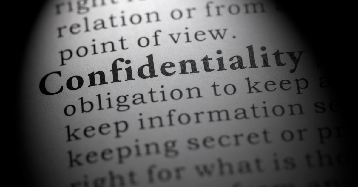 A dictionary page with the word “confidentiality” in bold type, surrounded by partially blurred definition text.
